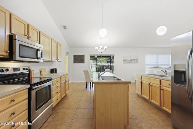 12394 Glenn Hollow Dr, Jacksonville, FL 32226 - kitchen featuring appliances with stainless steel finishes, an island with sink, a sink, light brown cabinetry, and lofted ceiling