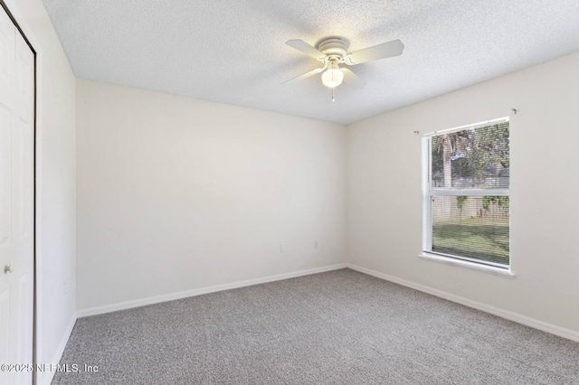 12394 Glenn Hollow Dr, Jacksonville, FL 32226 - spare room with plenty of natural light, a textured ceiling, a ceiling fan, carpet, and baseboards