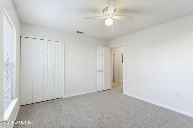 12394 Glenn Hollow Dr, Jacksonville, FL 32226 - unfurnished bedroom featuring carpet floors, baseboards, a closet, a textured ceiling, and a ceiling fan