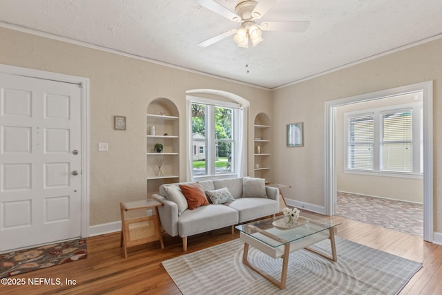 4534 College St, Jacksonville, FL 32205 - living room featuring wood-type flooring, crown molding, a textured ceiling, built in features, and baseboards