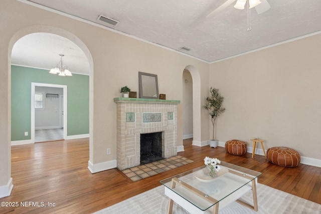 4534 College St, Jacksonville, FL 32205 - living area featuring arched walkways, hardwood / wood-style floors, crown molding, baseboards, and ceiling fan
