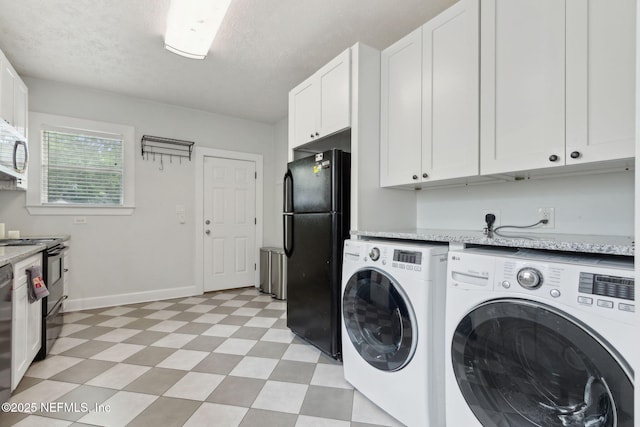 4534 College St, Jacksonville, FL 32205 - laundry area featuring light flooring, independent washer and dryer, baseboards, and a textured ceiling