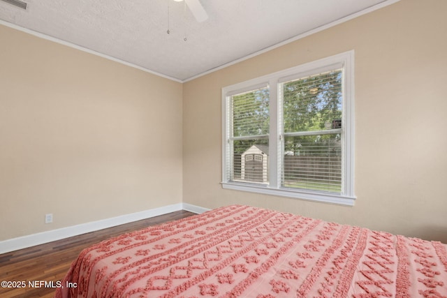 4534 College St, Jacksonville, FL 32205 - bedroom featuring dark wood finished floors, crown molding, baseboards, a textured ceiling, and a ceiling fan