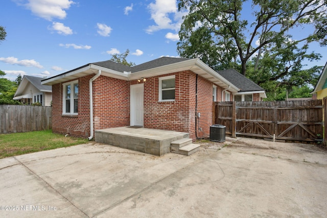 4534 College St, Jacksonville, FL 32205 - rear view of house featuring brick siding, roof with shingles, and a patio area