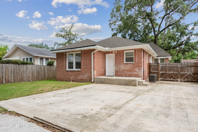 4534 College St, Jacksonville, FL 32205 - bungalow-style home with brick siding, a shingled roof, and central air condition unit