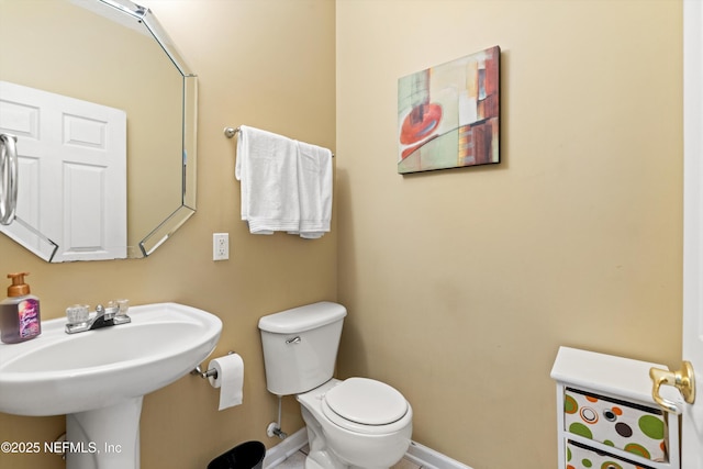 766 Candlebark Dr, Jacksonville, FL 32225 - bathroom with baseboards, toilet, and a sink
