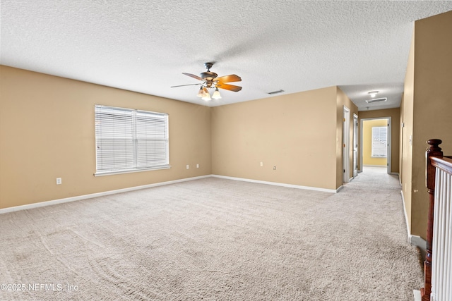 766 Candlebark Dr, Jacksonville, FL 32225 - empty room featuring light colored carpet, a ceiling fan, baseboards, and a textured ceiling