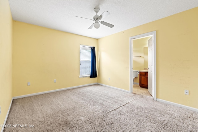 766 Candlebark Dr, Jacksonville, FL 32225 - unfurnished bedroom featuring light carpet, ensuite bathroom, baseboards, a textured ceiling, and a ceiling fan