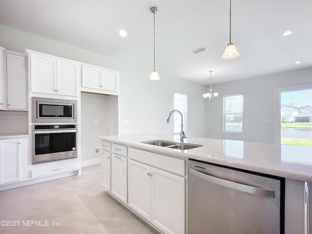 232 Caiden Dr, Ponte Vedra, FL 32081 - kitchen featuring white cabinets, appliances with stainless steel finishes, an inviting chandelier, a sink, and visible vents