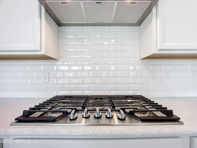 232 Caiden Dr, Ponte Vedra, FL 32081 - room details with white cabinets, tasteful backsplash, range hood, and stainless steel gas stovetop