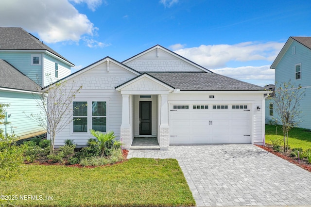 232 Caiden Dr, Ponte Vedra, FL 32081 - ranch-style house with decorative driveway, a front lawn, and a garage