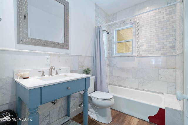 2720 Apache Ave, Jacksonville, FL 32210 - full bath featuring a sink, toilet, tile walls, wood finished floors, and shower / tub combo