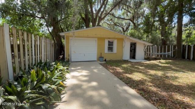 2720 Apache Ave, Jacksonville, FL 32210 - garage featuring fence and driveway