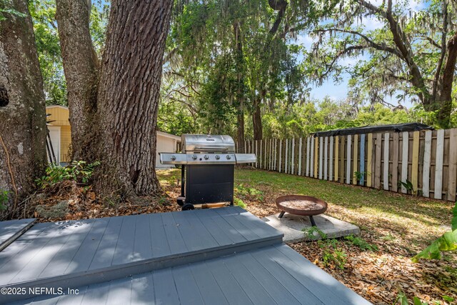 2720 Apache Ave, Jacksonville, FL 32210 - wooden deck featuring fence, a fire pit, and a grill