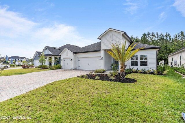 49 Golden Fern Dr, Saint Augustine, FL 32092 - view of front of home featuring an attached garage, decorative driveway, and a front yard