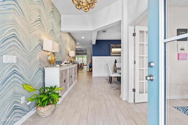 49 Golden Fern Dr, Saint Augustine, FL 32092 - foyer entrance with light wood finished floors, wallpapered walls, a notable chandelier, visible vents, and baseboards