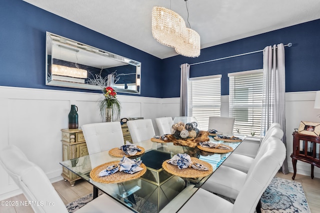 49 Golden Fern Dr, Saint Augustine, FL 32092 - dining room featuring a chandelier, a wainscoted wall, and wood finished floors