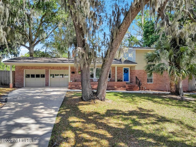 view of front of house with a garage, fence, a front yard, brick siding, and concrete driveway
