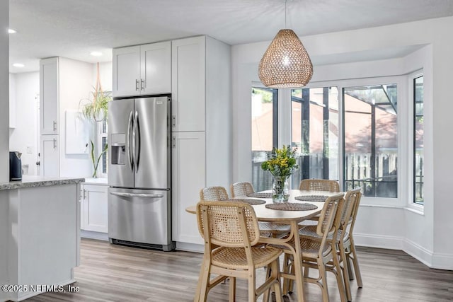 dining area featuring recessed lighting, light wood-style flooring, and baseboards