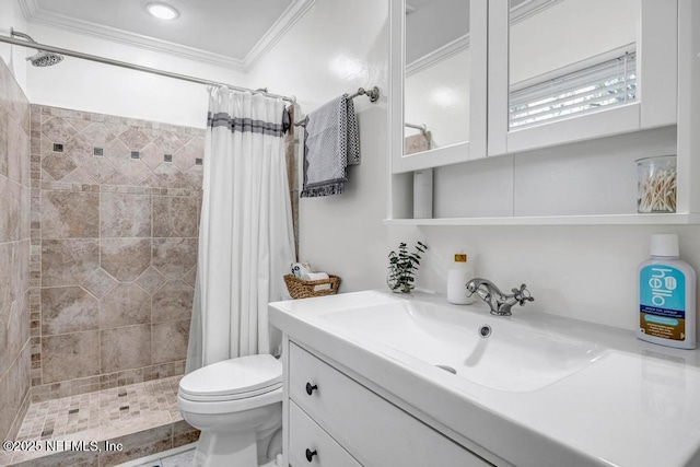 bathroom with crown molding, toilet, a shower stall, and vanity