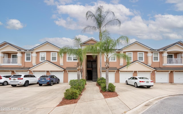 108 Brannan Pl Unit 103, Saint Johns, FL 32259 - view of property with an attached garage, driveway, and stucco siding