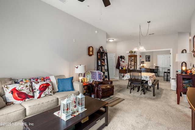 108 Brannan Pl Unit 103, Saint Johns, FL 32259 - living area with light carpet, a ceiling fan, and a chandelier