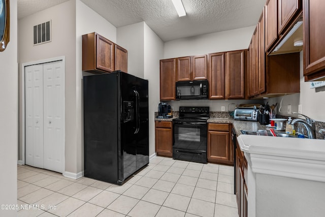 108 Brannan Pl Unit 103, Saint Johns, FL 32259 - kitchen featuring black appliances, a textured ceiling, light tile patterned flooring, and a sink