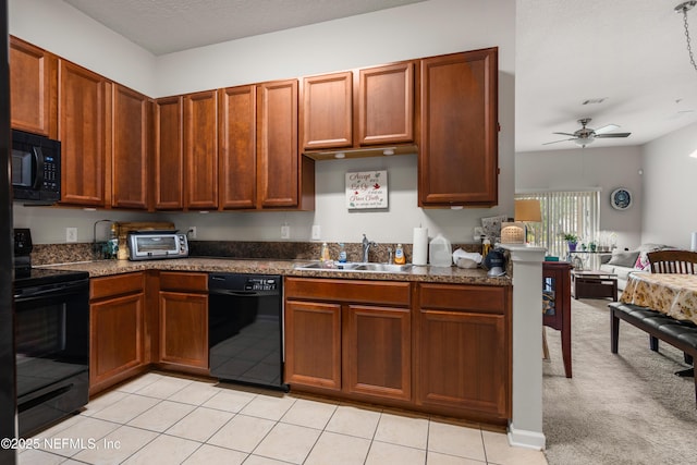 108 Brannan Pl Unit 103, Saint Johns, FL 32259 - kitchen featuring black appliances, a sink, ceiling fan, dark countertops, and open floor plan