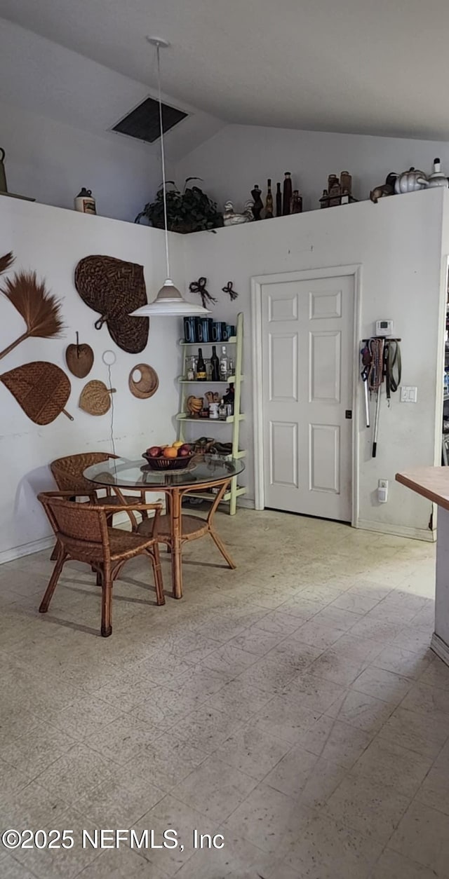 dining room featuring vaulted ceiling