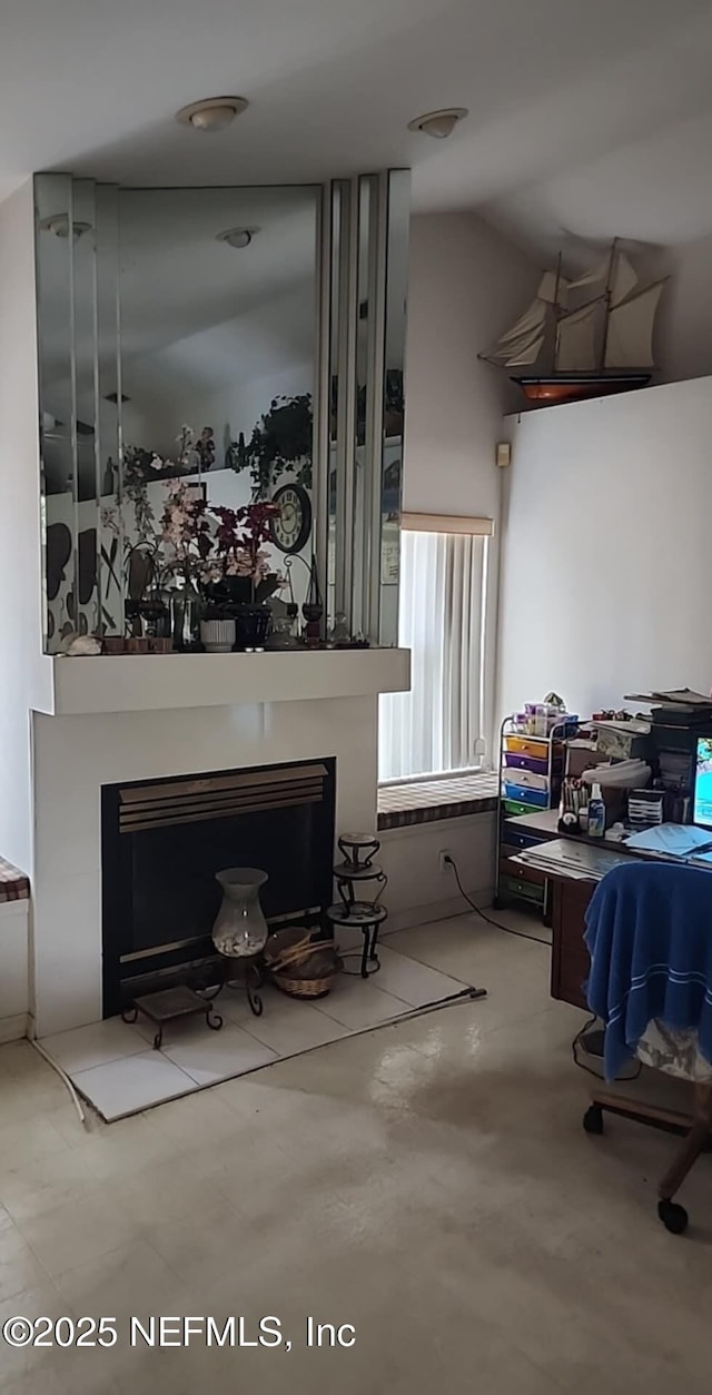 living room with a fireplace and lofted ceiling