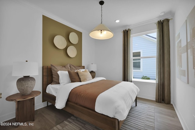 bedroom featuring recessed lighting, baseboards, ornamental molding, and wood finished floors