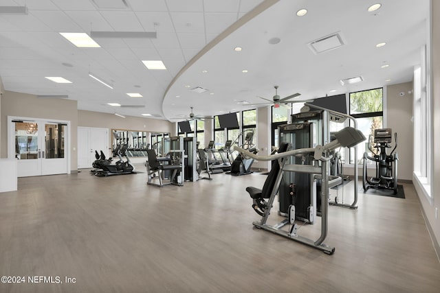 gym featuring recessed lighting, ceiling fan, a drop ceiling, and wood finished floors