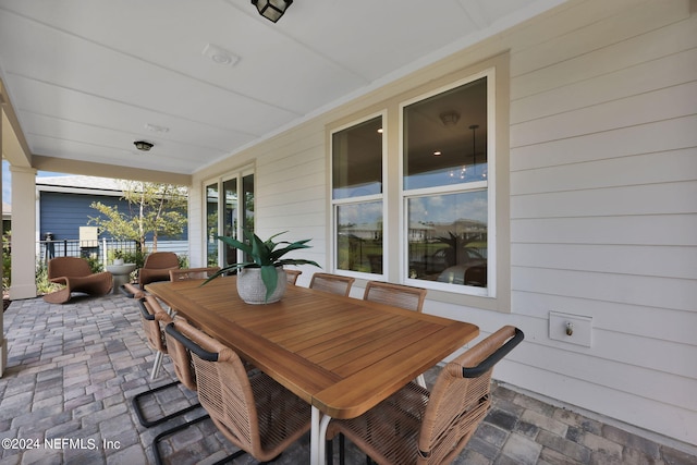 sunroom / solarium featuring wood walls