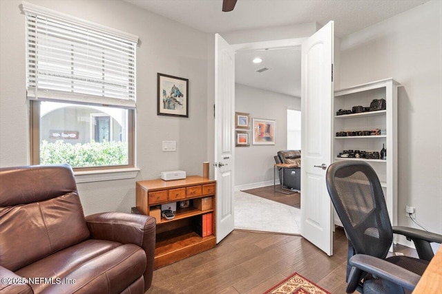office with dark wood-type flooring and ceiling fan