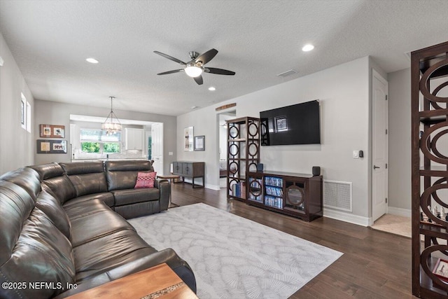 living area with recessed lighting, baseboards, visible vents, and ceiling fan with notable chandelier