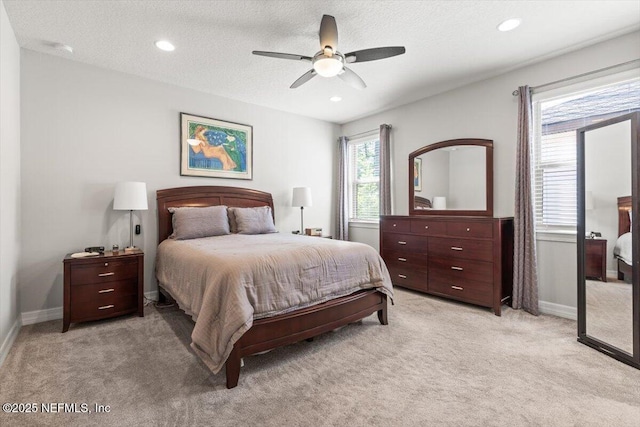 bedroom with recessed lighting, baseboards, and light carpet