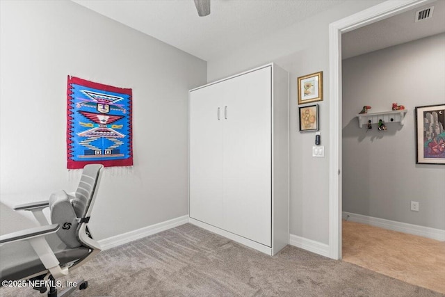 office with carpet flooring, a ceiling fan, baseboards, and visible vents