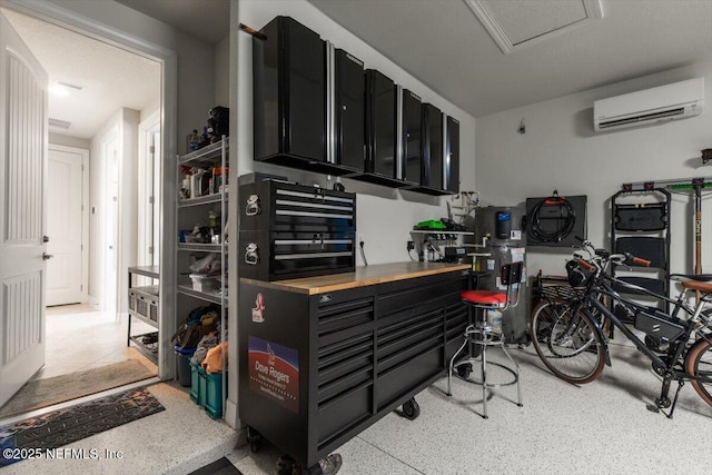 interior space with light speckled floor and a wall mounted air conditioner