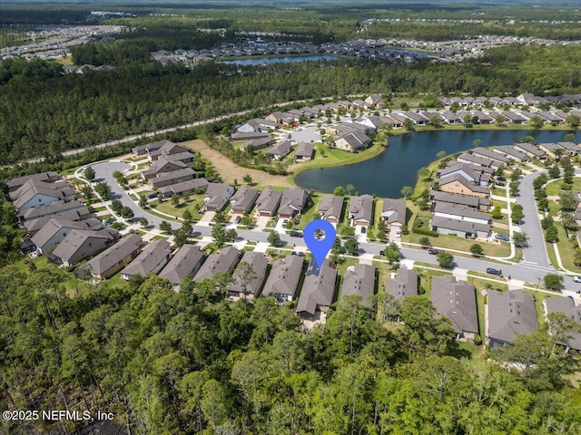birds eye view of property with a residential view, a water view, and a forest view