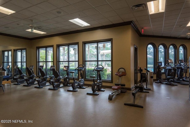 exercise room featuring ornamental molding and visible vents