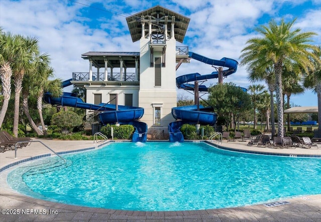 pool featuring a patio and a water slide