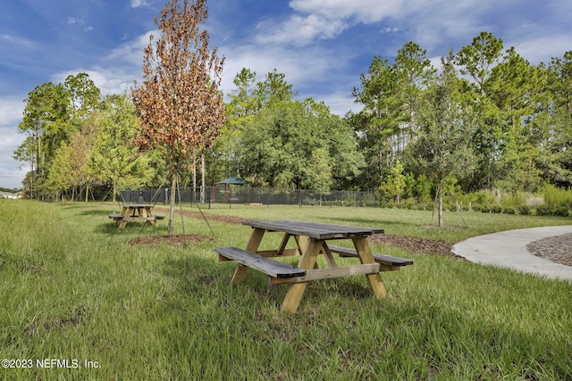 surrounding community featuring a lawn and fence