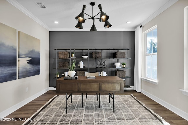 office space featuring crown molding, baseboards, wood finished floors, and visible vents