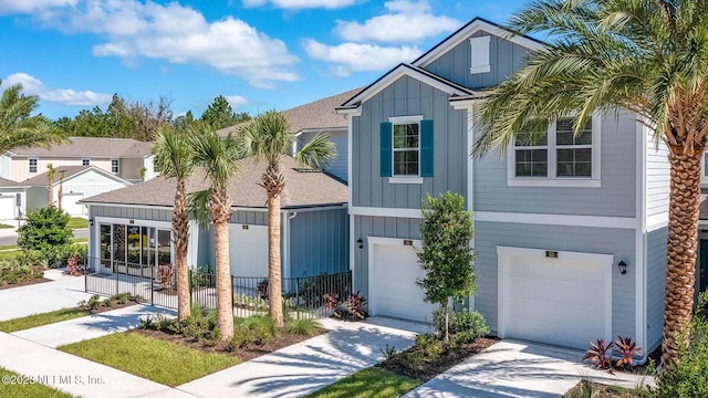 419 Seaport Breeze Rd, Saint Augustine, FL 32095 - traditional home featuring board and batten siding, an attached garage, fence, and concrete driveway