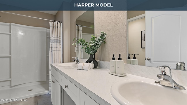 419 Seaport Breeze Rd, Saint Augustine, FL 32095 - bathroom featuring a shower with shower curtain, double vanity, tile patterned floors, and a sink