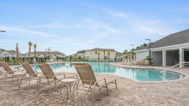 419 Seaport Breeze Rd, Saint Augustine, FL 32095 - community pool featuring a patio area, fence, and a residential view