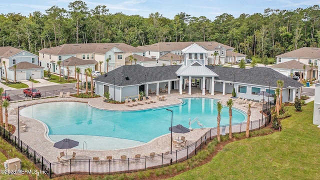 419 Seaport Breeze Rd, Saint Augustine, FL 32095 - community pool with a lawn, a view of trees, fence, and a residential view