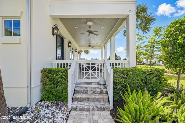 view of exterior entry with covered porch and ceiling fan
