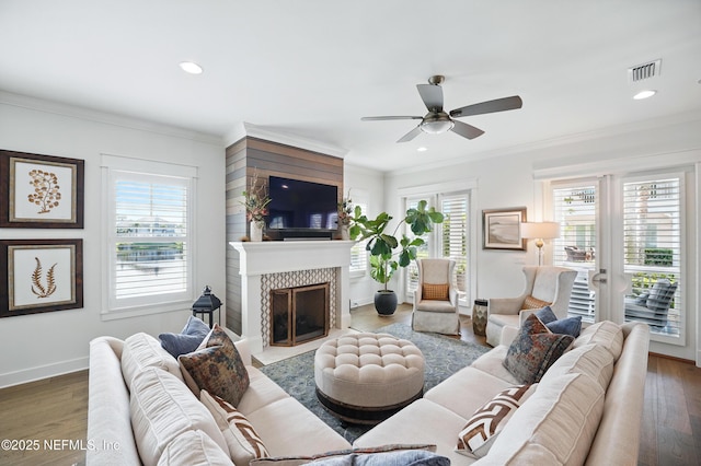 living room featuring recessed lighting, a fireplace with flush hearth, a ceiling fan, and wood finished floors