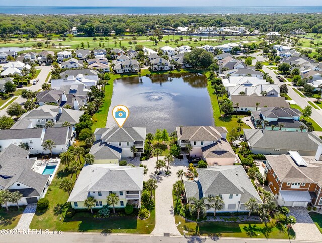 birds eye view of property with a water view and a residential view